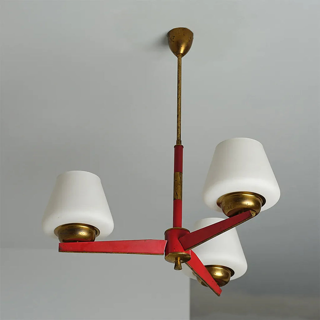 3 light chandeliers product image showing three white lampshades with a red and brass metal frame.
