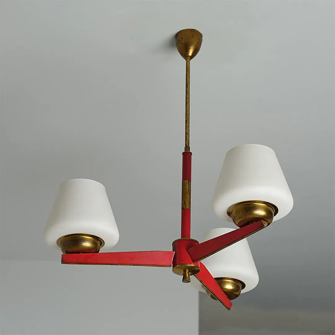 3 light chandeliers product image showing three white lampshades with a red and brass metal frame.