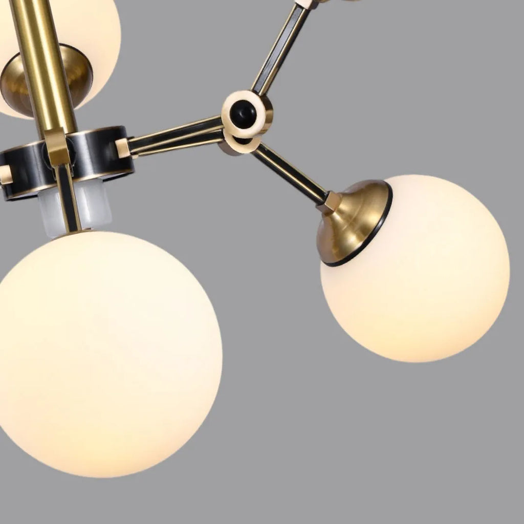 Close-up of bubble lighting chandeliers showing frosted glass spheres and brass light arms.