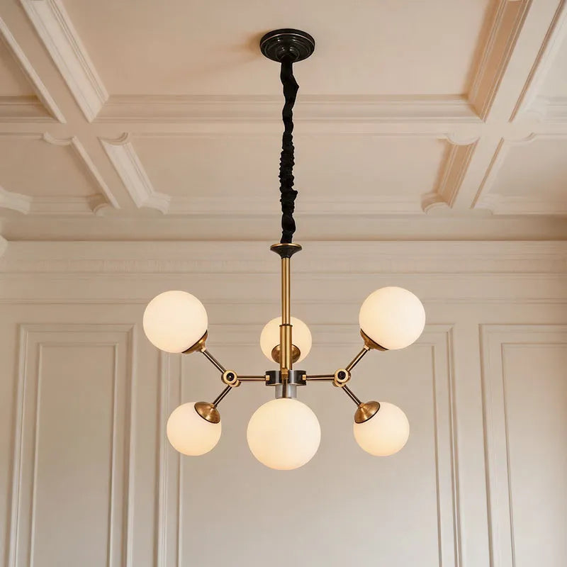 Bubble lighting chandeliers featuring frosted glass globe shades and a modern gold frame in a luxury room.