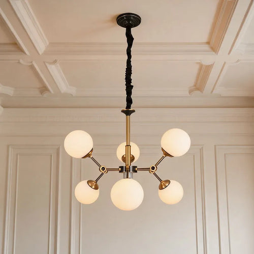 Bubble lighting chandeliers featuring frosted glass globe shades and a modern gold frame in a luxury room.