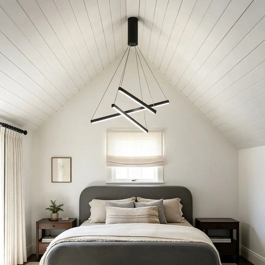 Criss linear chandelier installed in a bedroom with a minimalist crossed frame and modern ceiling design.