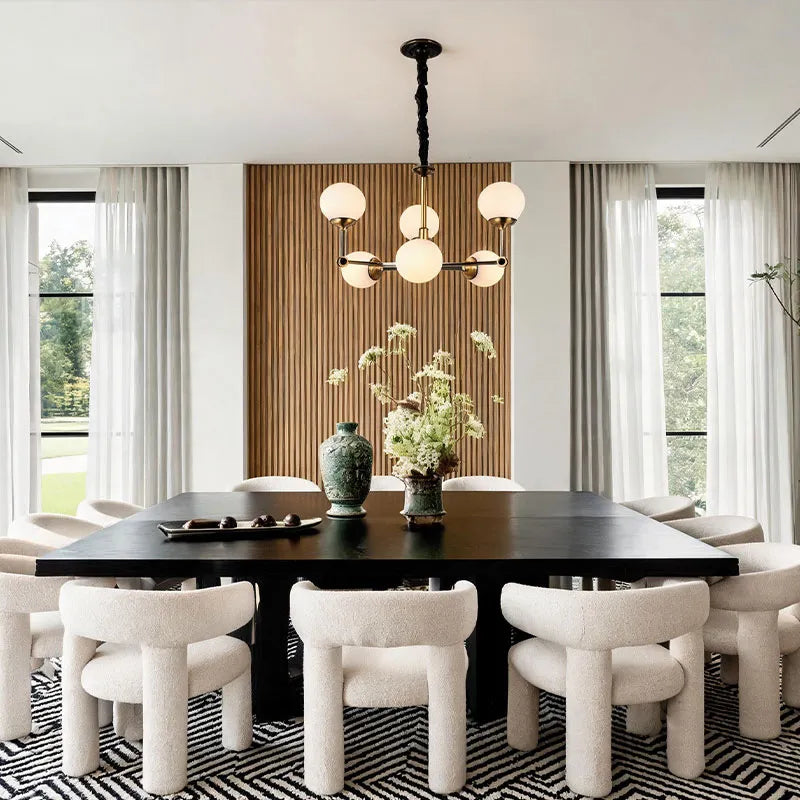 Glass ball chandelier modern featured in a dining area with a symmetrical globe light design.