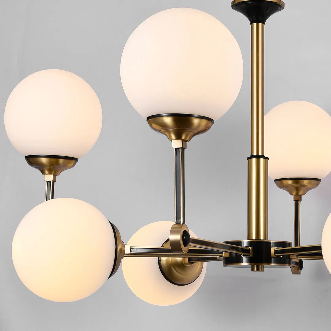 Glass ball chandelier modern close-up showing frosted glass globes and curved brass light arms.