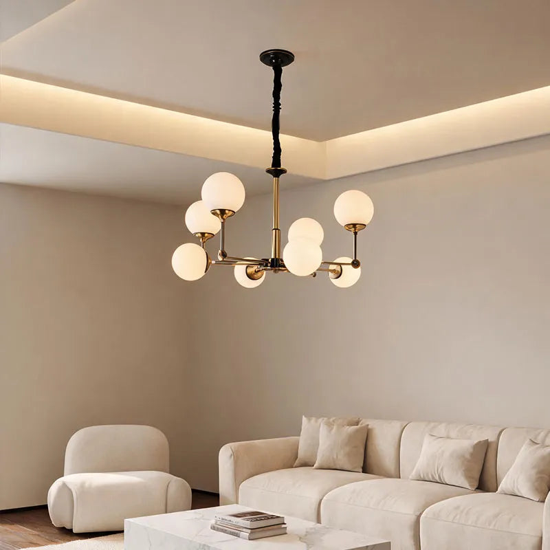Glass ball chandelier modern installed in a bright living room with warm ambient lighting.