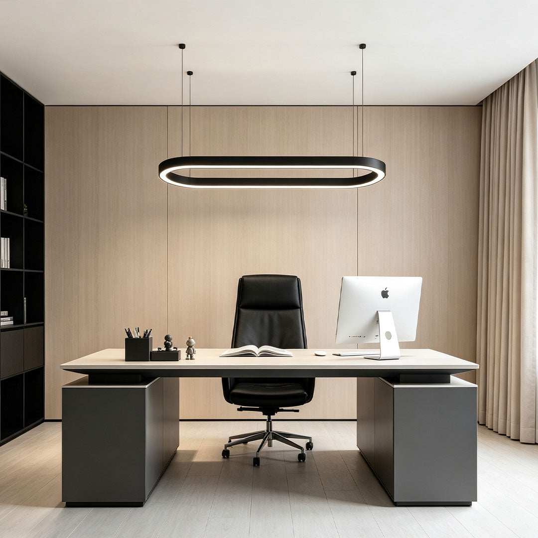 Modern oval chandelier suspended above a minimalist executive office desk.