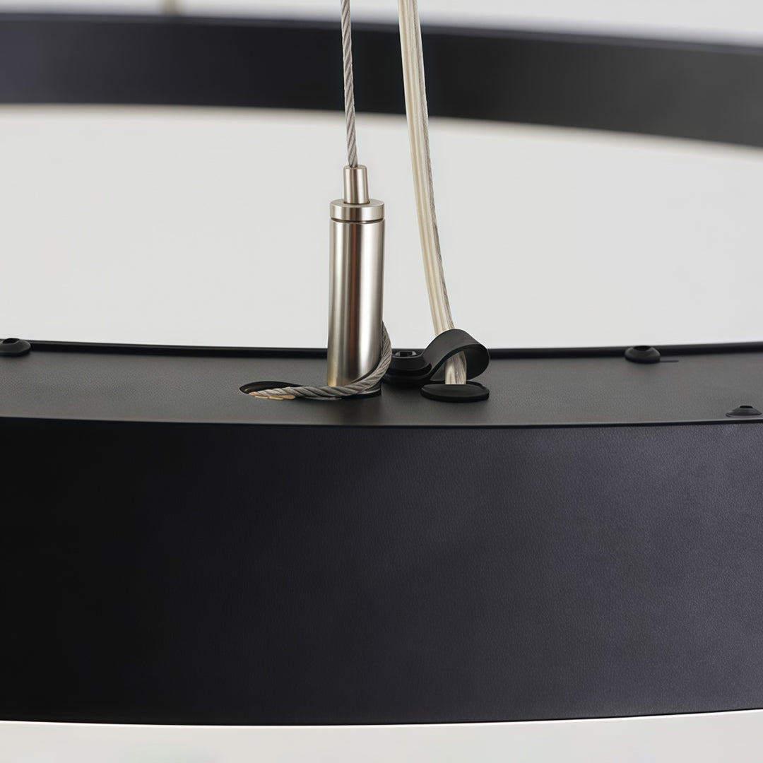 Close-up detail of oval chandelier suspension cable and mounting hardware.